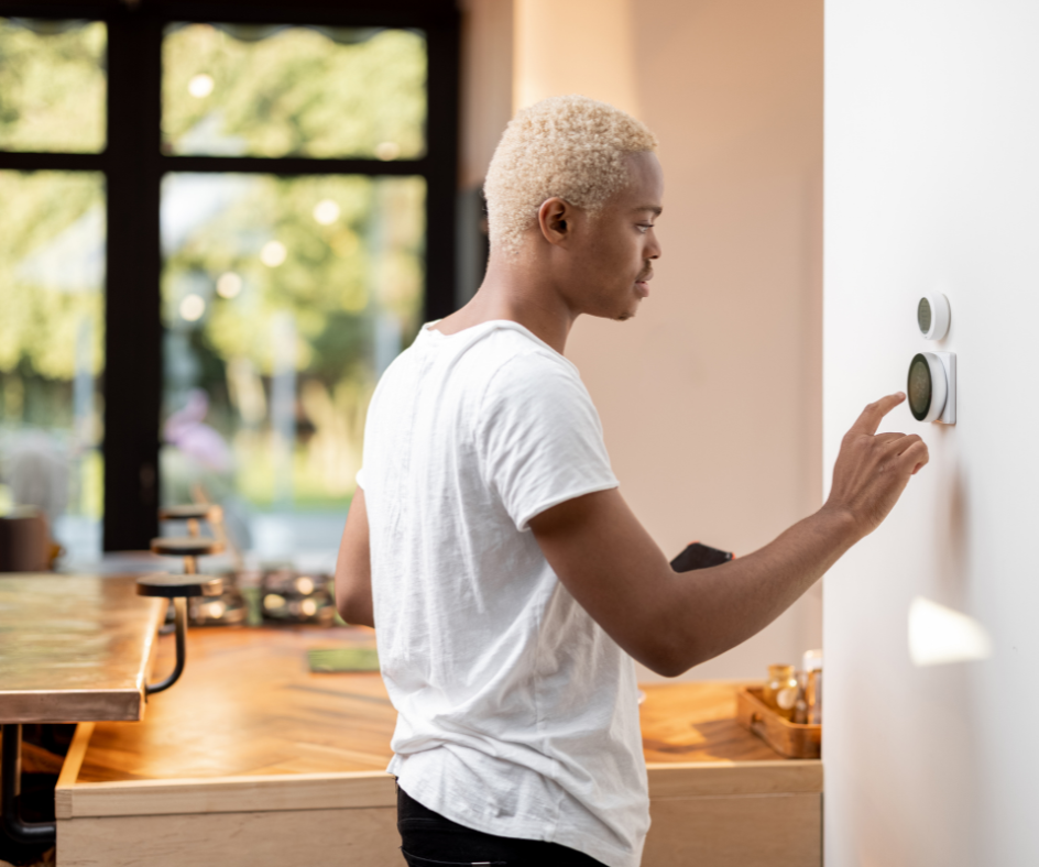 Man changing smart thermostat