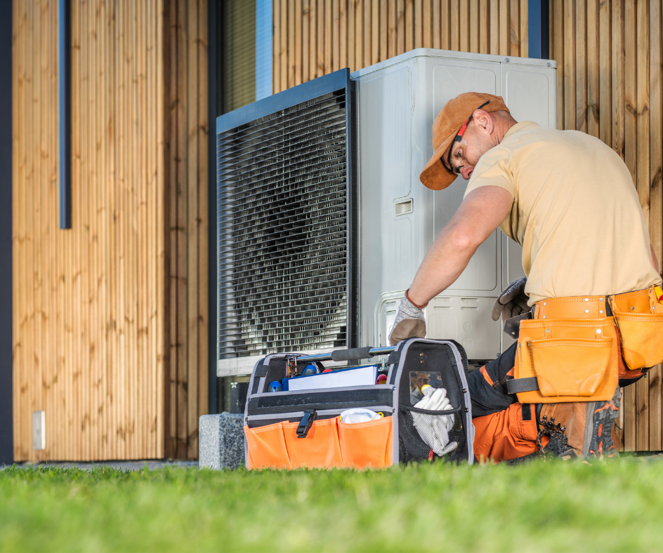 HVAC Tech working on a unit outside a house